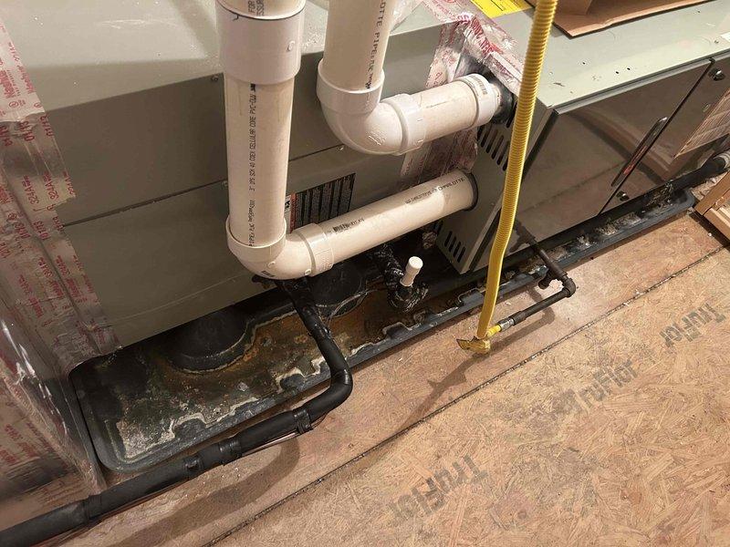 Performed Care Plan Tune Up service on the AC/gas furnace system located in attic. Inspected system components including condensate drain line and drain pan, which showed normal moisture collection. Verified proper operation of the digital thermostat which displayed 72° current temperature with heating (71°) and cooling (76°) setpoints functioning properly. Customer supplies their own filters as noted.