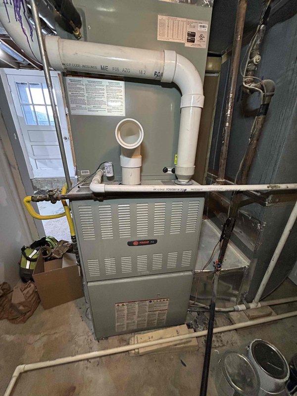 Diagnosed no-heat condition on 6-year-old Trane gas furnace reporting pressure switch error. Upon inspection, found faulty draft inducer motor (identified by C3/P01 labeling) preventing proper combustion sequence. Replaced inducer motor assembly, verified proper pressure switch operation, and confirmed normal heating cycle resumed with appropriate flame sensing and temperature rise.