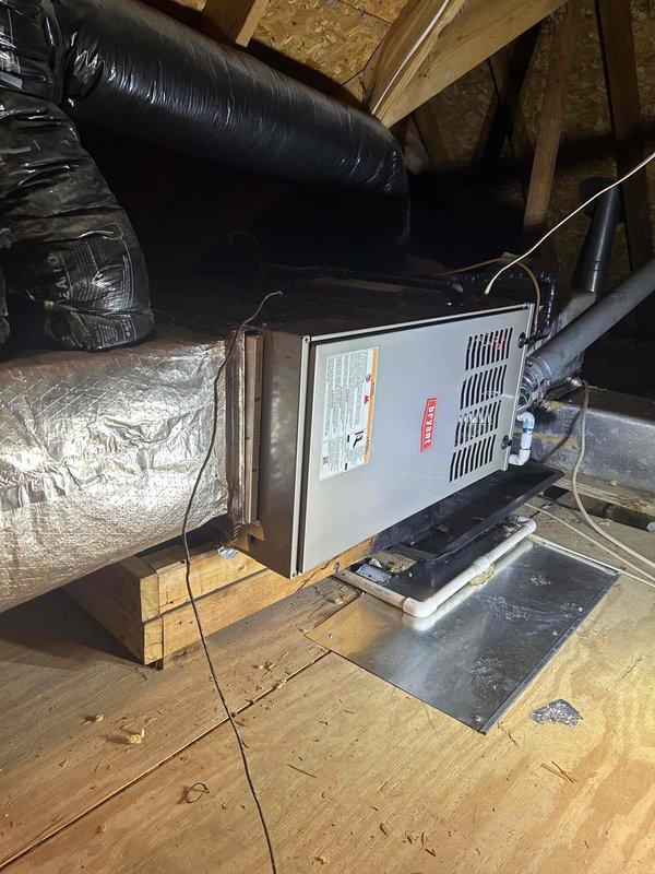 Completed installation of Bryant 800SB42045M17 furnace in attic location with all required connections including flexible gas line, electrical shut-off switch, and flue piping. System includes standard air filter rack, transition to evaporator coil, and flame roll-out protection. Post-installation testing confirmed proper gas pressure readings of 35.0/35.1 inWC.