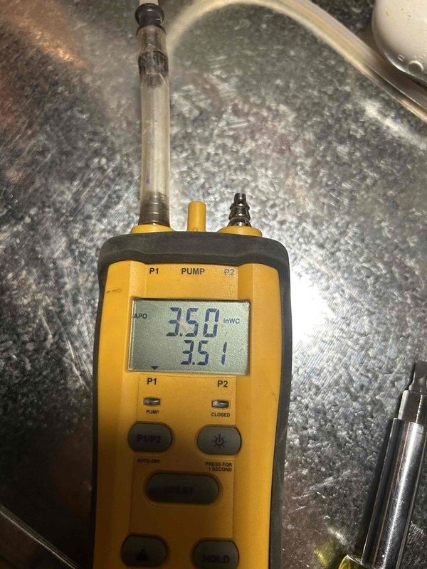 Completed installation of Bryant 800SB42045M17 furnace in attic location with all required connections including flexible gas line, electrical shut-off switch, and flue piping. System includes standard air filter rack, transition to evaporator coil, and flame roll-out protection. Post-installation testing confirmed proper gas pressure readings of 35.0/35.1 inWC.