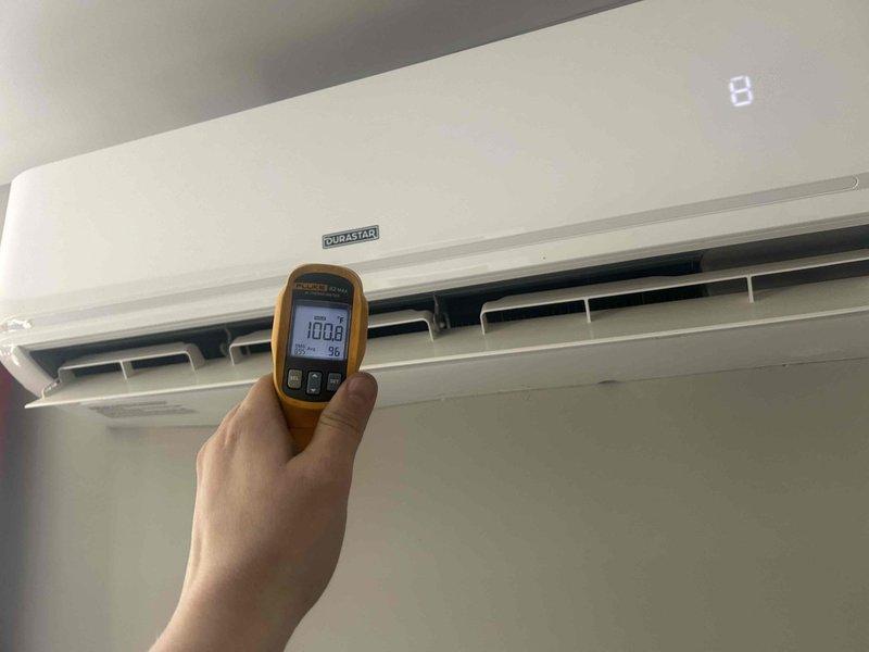 Responded to call back regarding leak issues during warmer conditions. Located and accessed plumbing components behind wall panel, inspected copper lines for corrosion and mineral buildup at connection points. Performed temperature differential testing on Dynastar wall-mounted unit, recording readings of 100.8°F/98°F to verify proper operation after leak repair.