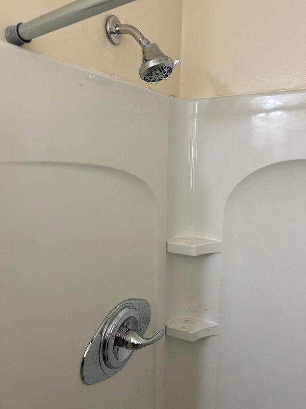 Replaced failed Delta shower valve that had frozen and burst with new Delta valve and remodel plate. Identified partial failure of main water shutoff valve during service. Verified complete repair with leak check and functionality test of new shower components.