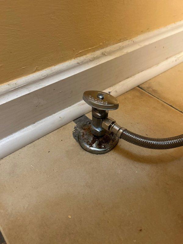 Responded to service call for toilet leak. Identified corroded supply valve with rusting base plate as source of constant leak. Replaced damaged valve and braided metal supply line, ensuring proper connection to copper supply pipes. Tested system for proper operation and verified no further leakage.