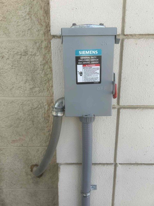Completed installation of a Bryant 5-ton Gas Package AC Unit (model 582LP06A110A2A0AA) with manual damper on commercial property. Connected unit to existing interior duct system, installed digital thermostat, secured two poly pads for proper mounting, and completed gas line installation. Verified proper electrical connection to the Siemens enclosed switch and ensured all connections meet code requirements.