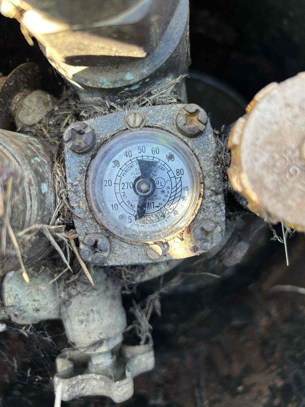 Responded to callback for system periodically freezing up with indoor temperature at 49°F. Upon inspection, found severely dirty pressure/temperature gauge and examined heat exchange components. System was thawed for proper troubleshooting and diagnostics.