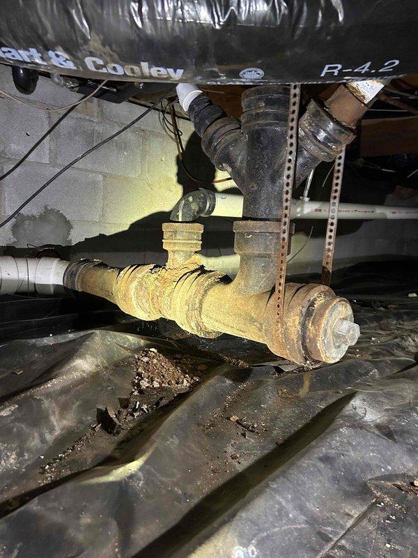 Inspected customer's crawlspace plumbing system and identified severely corroded brass pipe fittings with significant mineral buildup at connection points. Observed damaged insulation on nearby ductwork with torn foil backing. Recommended replacement of deteriorated pipe connectors to prevent potential leaks and system failure.