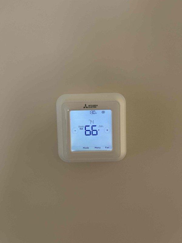 Returned to site to complete HVAC installation warranty work. Successfully evacuated the garage system and performed full system startup as previously scheduled. Verified proper operation of the Mitsubishi Electric thermostat (currently set to Heat mode at 66°F) and confirmed installation of the Diversitech electrical junction box on the exterior wall.