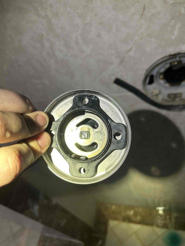 Responded to service call for water leak from a water softener tank causing air in lines. Diagnosed leaking manifold system with multiple connection points showing moisture accumulation. Replaced faulty circular metal connector component and restored proper function to water distribution system, eliminating both the leak and air infiltration issues.