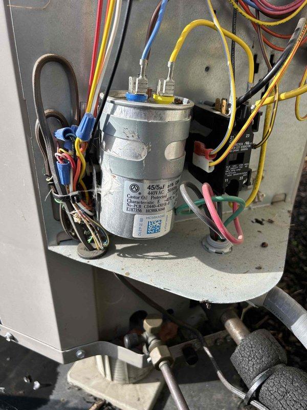 Completed second service ticket of a 10-year care plan for GEO system, working in conjunction with Trio technician at the same location. Inspected blower wheel assembly which showed normal dust accumulation. Examined electrical components including capacitor and associated wiring connections (blue, yellow, red, black, and pink) within the unit cabinet, verifying proper installation and function.