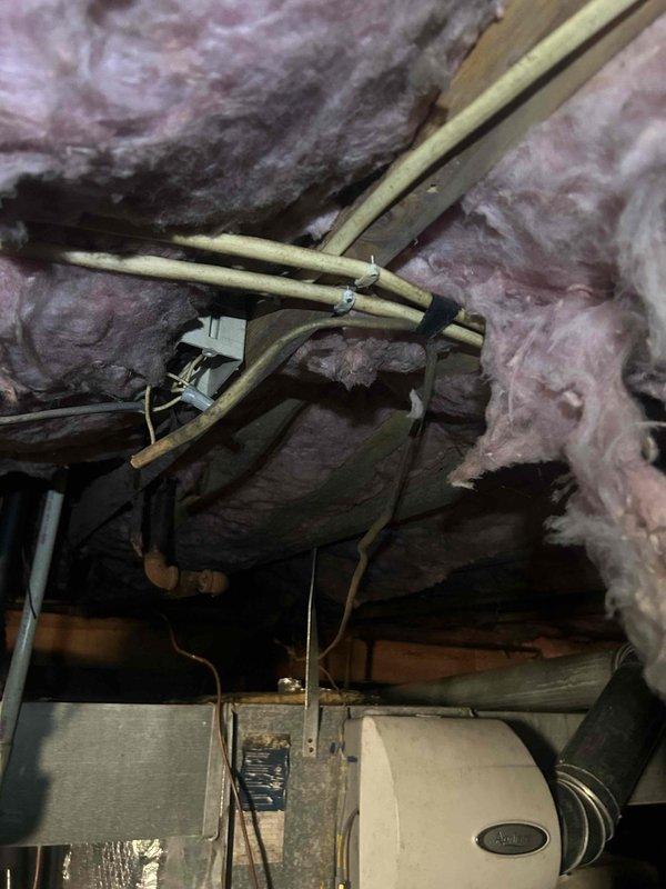 Responded to emergency no-heat call for two electric HVAC systems (6 and 11 years old) with recurring breaker trips. Inspection of attic and crawlspace units revealed improper electrical connections at junction box with exposed wiring and deteriorated insulation. Repaired faulty wiring connections, secured loose terminals, and reset breakers to restore proper operation to both systems.