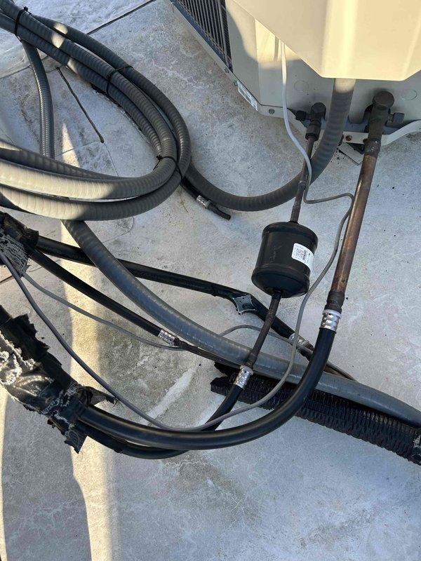 Responded to commercial no heat service call for rooftop unit. Upon inspection, discovered failed refrigerant drier component in refrigeration lines causing system malfunction. Replaced filter drier and reconnected copper refrigerant lines, then verified proper system operation with heat functioning correctly.