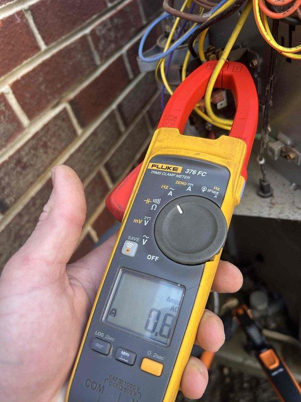 Performed Care Plan Tune Up on heat pump/air handler located in basement. Conducted electrical testing using Fluke 376 FC clamp meter, confirming proper amperage readings with measurements at 0.0A and 18.2A across system components. Replaced customer-supplied 20x20x1 air filter as part of routine maintenance.