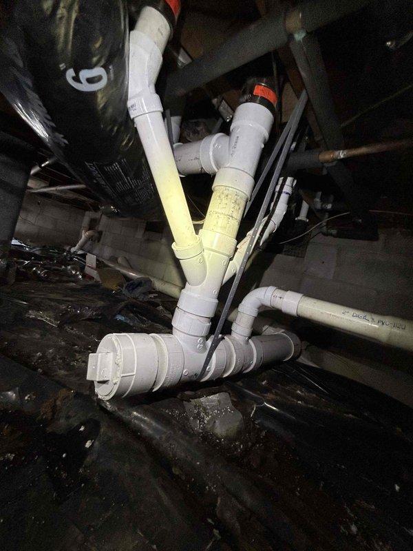 Replaced deteriorated cast iron drain line and lead toilet riser in crawlspace with new 4" PVC piping. Successfully tied into existing cast iron vent and installed new vertical and horizontal drain lines for proper drainage. Verified system operation with no leaks before completing service.