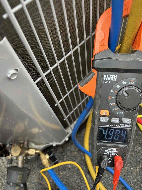 Performed annual care plan tune-up on HP/AH unit located in closet. Conducted electrical testing with Klein Tools CL710 multimeter, measuring voltage readings of 49.84V and 29.94V at various points to verify proper electrical operation. Inspected existing 20x20x1 air filter and discussed replacement options with customer.