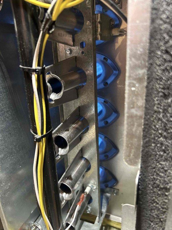 Performed scheduled Care Plan tune-up on AC and gas furnace after 3:00 PM as requested by customer. Inspected burner assembly for proper combustion, observing clean blue flames indicating efficient operation. Checked gas line connections and verified proper installation of insulated ductwork and electrical components.