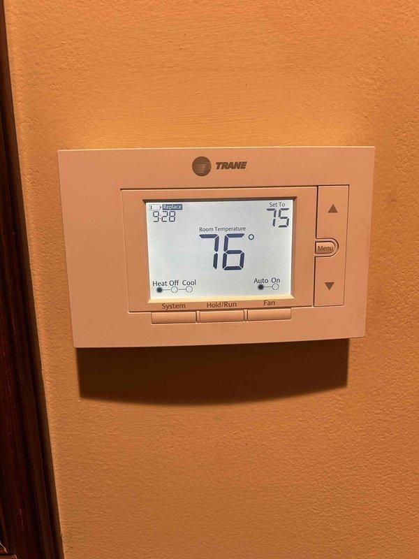 Performed Care Plan Tune Up on AC/GF system located in crawl space. Inspected Trane thermostat showing proper operation in cooling mode (76°F room/75°F set). Examined heat exchanger tubes, electrical components, and control panel - all functioning normally. Verified Aprilaire #210 filter installation as part of the maintenance service.