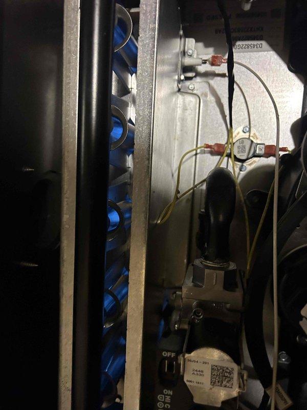 Performed Care Plan Tune Up on AC/GF system located in crawl space. Inspected Trane thermostat showing proper operation in cooling mode (76°F room/75°F set). Examined heat exchanger tubes, electrical components, and control panel - all functioning normally. Verified Aprilaire #210 filter installation as part of the maintenance service.