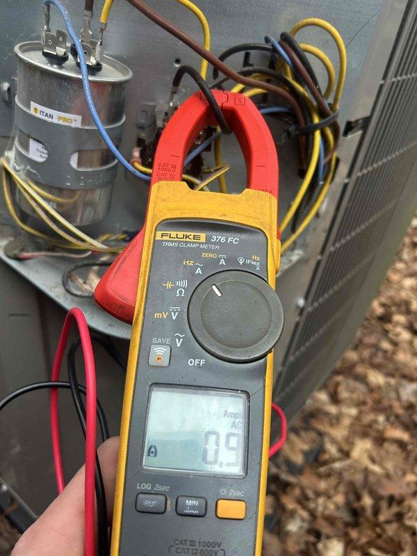 Performed scheduled Care Plan tune-up on AC/GF system located in crawl space. Conducted electrical testing with Fluke 376 FC clamp meter, measuring amperage draw at 0.9A and verified capacitor function on the TITAN PRO unit. System operating at proper temperature parameters with readings showing 58 degrees, indicating normal operation.