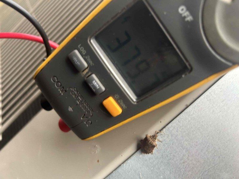 Performed scheduled Care Plan tune-up on AC/GF system located in crawl space. Conducted electrical testing with Fluke 376 FC clamp meter, measuring amperage draw at 0.9A and verified capacitor function on the TITAN PRO unit. System operating at proper temperature parameters with readings showing 58 degrees, indicating normal operation.