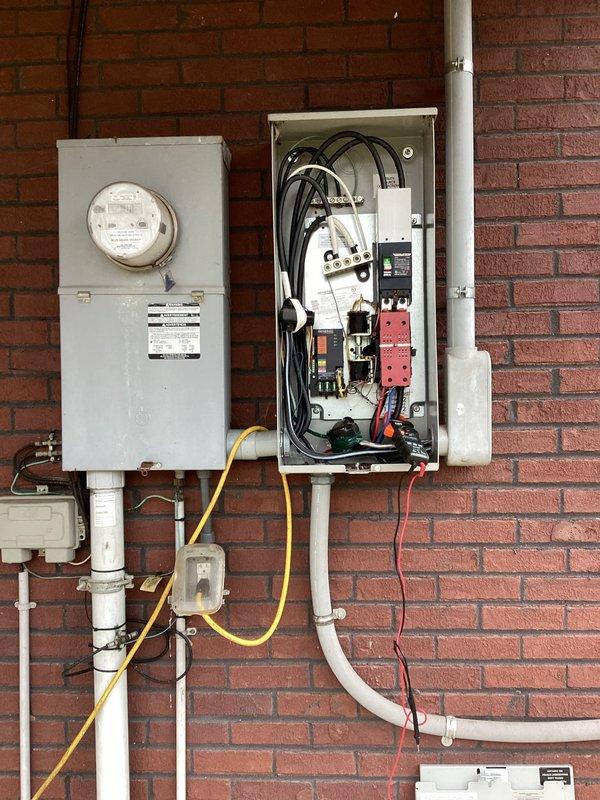 Diagnosed load shedding issue with primary generator and identified incorrect air filter installation on secondary generator. Inspected electrical service panel connections and outdoor condenser unit to verify proper integration with generator systems.