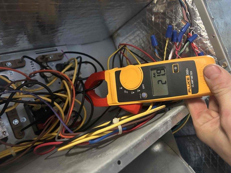 Performed scheduled Care Plan Tune Up on heat pump and air handler located in basement. Conducted comprehensive electrical inspection with clamp meter, confirming proper current draw of 21 amps and verifying integrity of all electrical connections. System components, including capacitor, contactor, and circuit board, were found in good working condition with no issues detected.