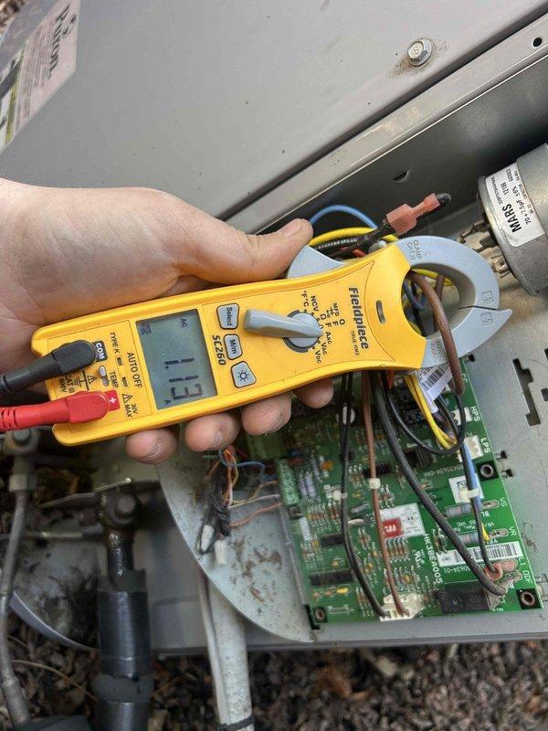 Performed annual maintenance on 10-year-old AC system. Conducted electrical diagnostic testing with Fieldpiece meter, measuring amperage draw (11.5) and voltage (1.13) at circuit board connections. System is functioning properly with all components in normal operating condition.