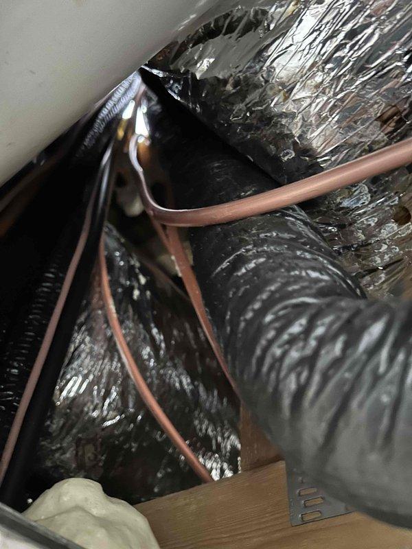 Successfully removed existing yoga pipe line set and installed new 3/4" x 3/8" copper refrigerant lines for HVAC system. Performed pressure testing with nitrogen to verify system integrity, evacuated system to manufacturer specifications, and recharged with R-410A refrigerant. Documented installation with photos showing the insulated ductwork and copper line connections.