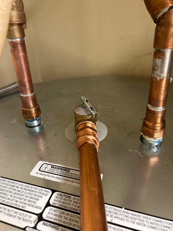 Responded to callback regarding water heater installed one month prior that was not heating properly and producing loud noise. Inspection revealed problems with the copper pipe connections to the water heater. Repaired faulty soldering at multiple connection points and properly secured brass valve fittings, resolving both the heating malfunction and noise issue.