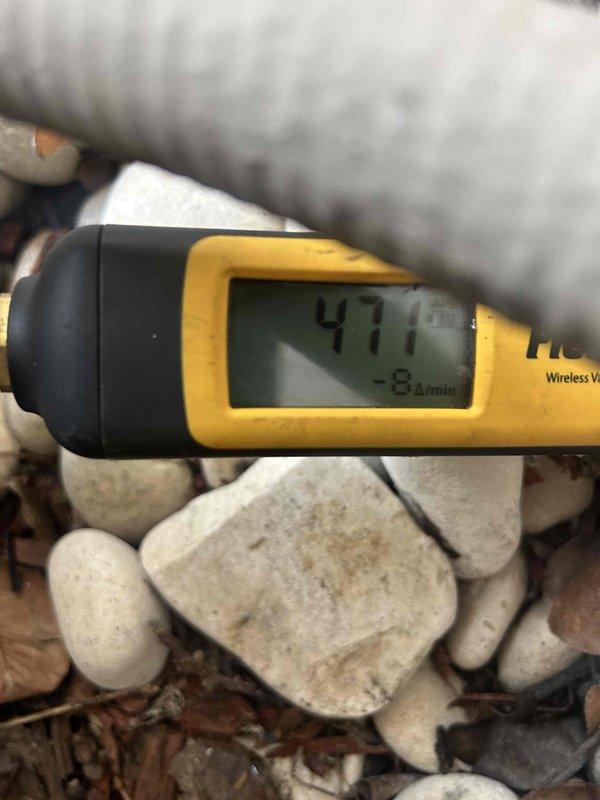 Performed warranty compressor replacement and leak repair on HVAC system. Conducted refrigerant leak detection (471 ppm with -8.4/min rate) and verified proper system operation post-repair with supply air temperature reading 56.5°F through register.