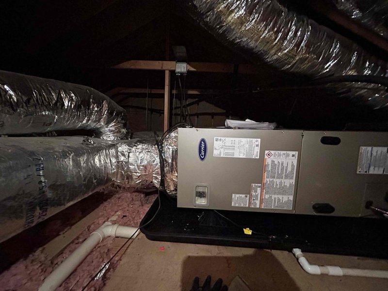 Successfully installed complete Carrier heat pump system (model CE27SCA530A003) with air handler (model CEFJ5ANXB30L00) and 10KW heat kit. Installation included outdoor unit placement on concrete pad with protective features (snow legs, disconnect box, refrigerant line filter) plus interior air handler setup with safety features (SS2 coil drain sensor, overflow pan with water sensor) and connection to existing ductwork and media filter cabinet as requested by customer.