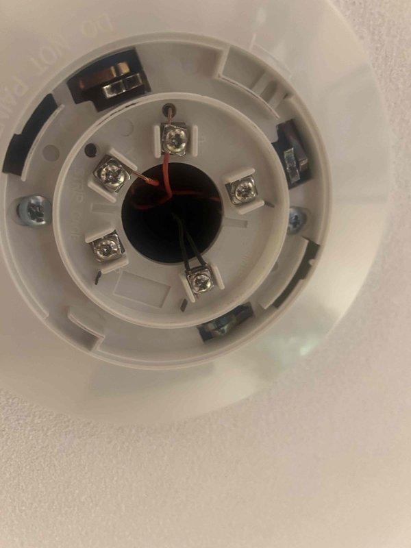 Responded to service call regarding a beeping smoke detector. Upon inspection, removed and examined two ceiling-mounted smoke detectors, checking terminal connections and internal components. Successfully diagnosed the issue, reattached the devices to their ceiling mounts, and verified proper operation with no further alarm activation.