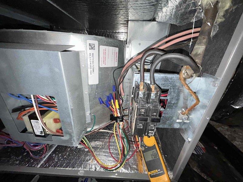 Performed annual Care Plan Tune Up on heat pump/air handler system located in attic. Conducted electrical testing using Fluke 323 clamp meter, measuring amperage draw (2.00A) and voltage (190V) at control board. Inspected internal components and wiring connections to ensure proper operation of system.