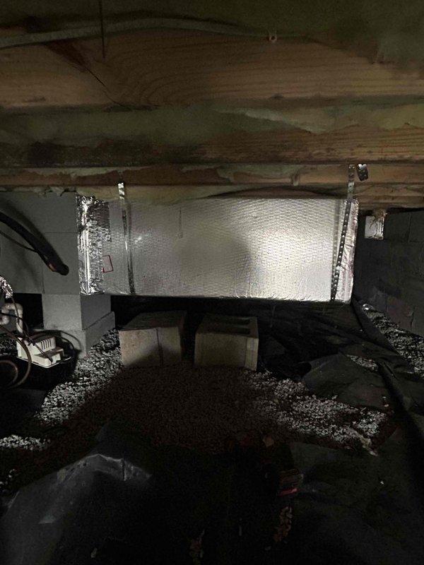 Responded to a non-urgent demand service call regarding high electric bills. Conducted thorough inspection of HVAC system with particular focus on ductwork in the crawl space. Observed significant issues with duct insulation integrity and sealing, documenting multiple areas where reflective insulation was compromised and connections needed re-sealing to prevent energy loss.