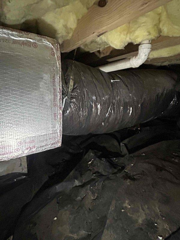 Responded to a non-urgent demand service call regarding high electric bills. Conducted thorough inspection of HVAC system with particular focus on ductwork in the crawl space. Observed significant issues with duct insulation integrity and sealing, documenting multiple areas where reflective insulation was compromised and connections needed re-sealing to prevent energy loss.