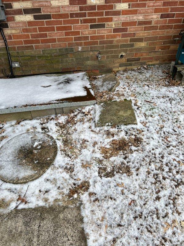 Conducted site assessment for sump pump reroute project, documenting existing conditions including discharge points on exterior brick wall showing signs of moisture damage. Quote for proposed work was prepared and will be sent to homeowner via email.