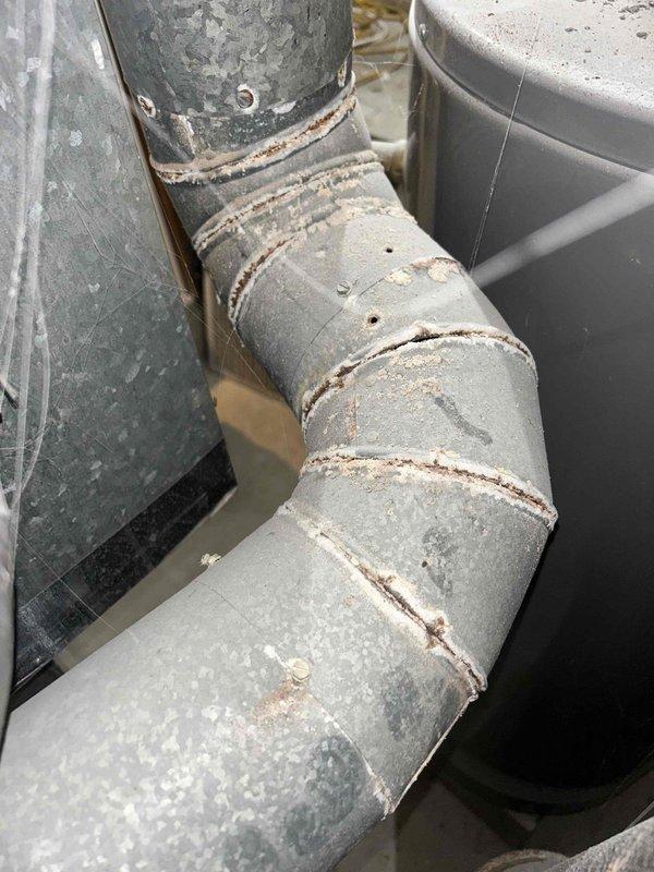 Responded to no-heat emergency call for a residence with 30-year-old thermostat and complete system failure. Upon inspection, found significant deterioration and dust accumulation in the ductwork with visible corrosion at connection points and joint seams. Replaced obsolete thermostat, cleaned critical components, and restored heating functionality to prevent potential freeze damage to the property.