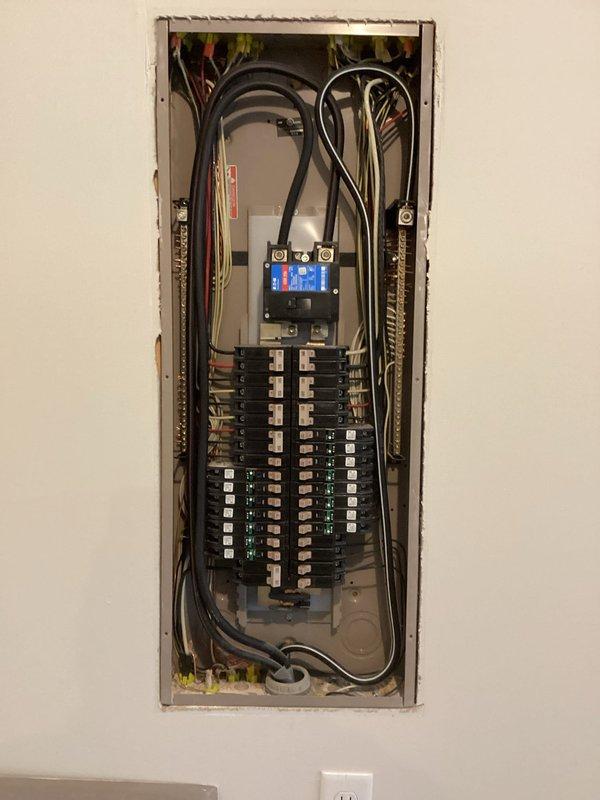 Conducted comprehensive evaluation of existing electrical panel and exterior utility connections for generator installation compatibility. Inspection revealed standard residential panel with adequate circuit capacity and well-organized wiring configuration. Documented exterior mounting location adjacent to existing meter and AC condenser, noting appropriate clearances and connection points for the proposed generator system.