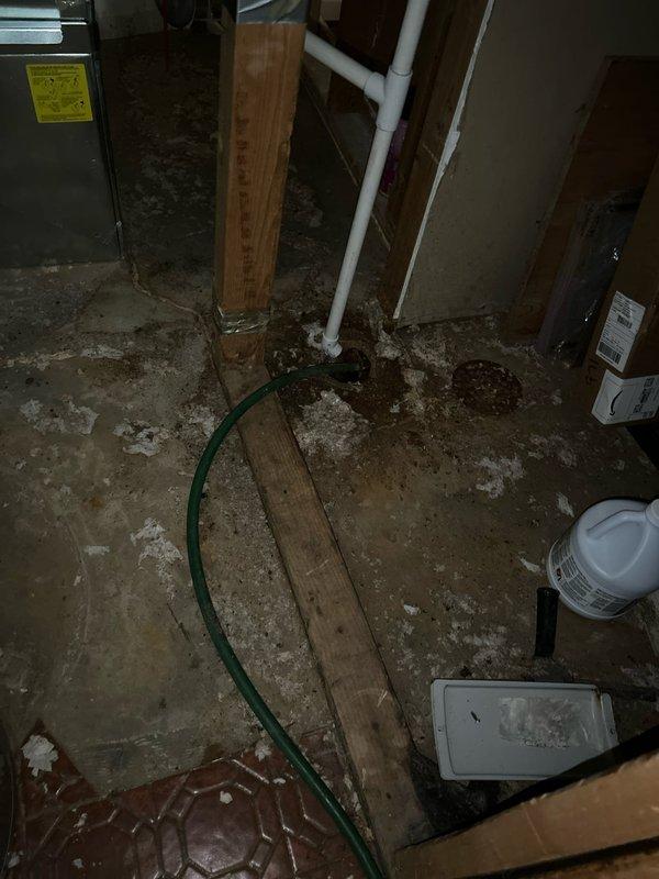 Responded to a water leak service call and found dried water in the utility room with residual moisture in the garage's back left corner behind the wall near the washer/utility sink. After inspection, determined the leak source was plumbing connected to the washer/utility sink, not the HVAC system. Installed a 45-degree coupling to improve drainage angle and verified proper operation by flushing the system.