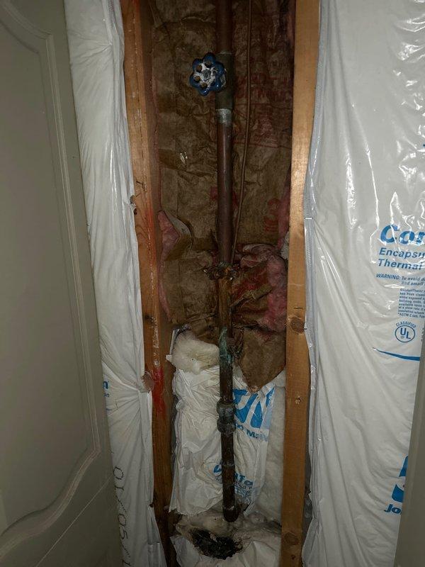 Responded to a water leak service call and found dried water in the utility room with residual moisture in the garage's back left corner behind the wall near the washer/utility sink. After inspection, determined the leak source was plumbing connected to the washer/utility sink, not the HVAC system. Installed a 45-degree coupling to improve drainage angle and verified proper operation by flushing the system.
