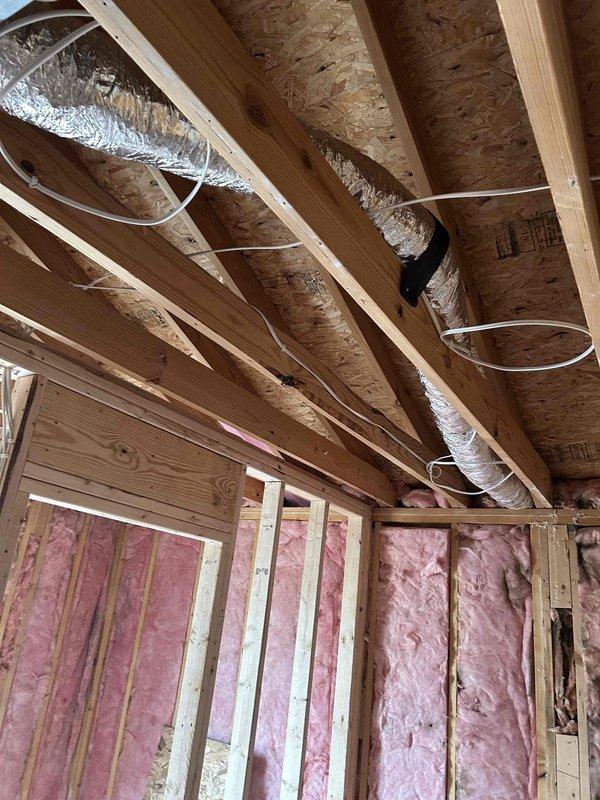Successfully relocated and installed flexible ductwork for two bathroom exhaust fans, ensuring proper support with metal strapping and connection to the existing HVAC system. Completed installation during the construction phase while insulation was being installed, allowing for optimal positioning of the flexible metal ducts before wall enclosure.