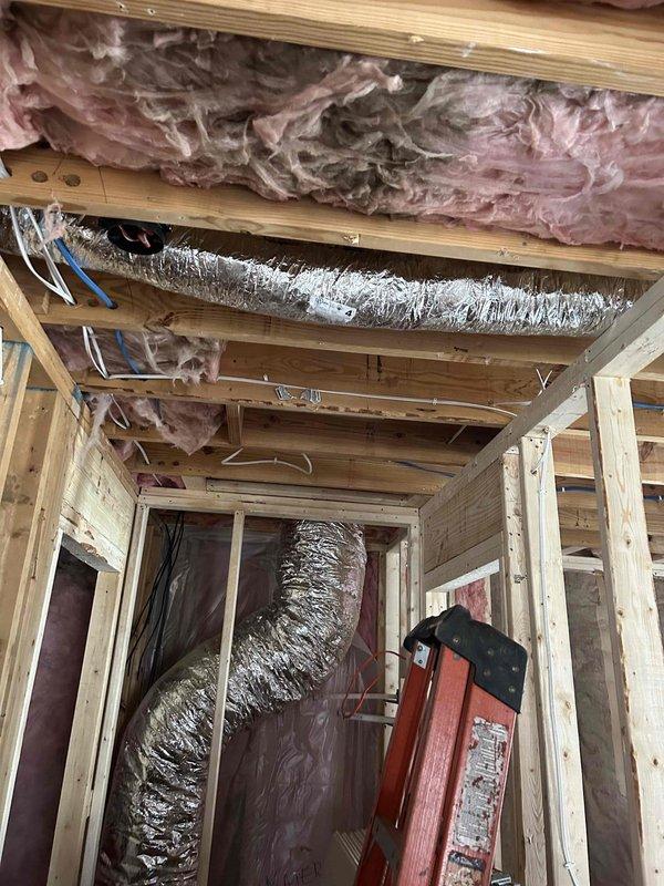 Successfully relocated and installed flexible ductwork for two bathroom exhaust fans, ensuring proper support with metal strapping and connection to the existing HVAC system. Completed installation during the construction phase while insulation was being installed, allowing for optimal positioning of the flexible metal ducts before wall enclosure.