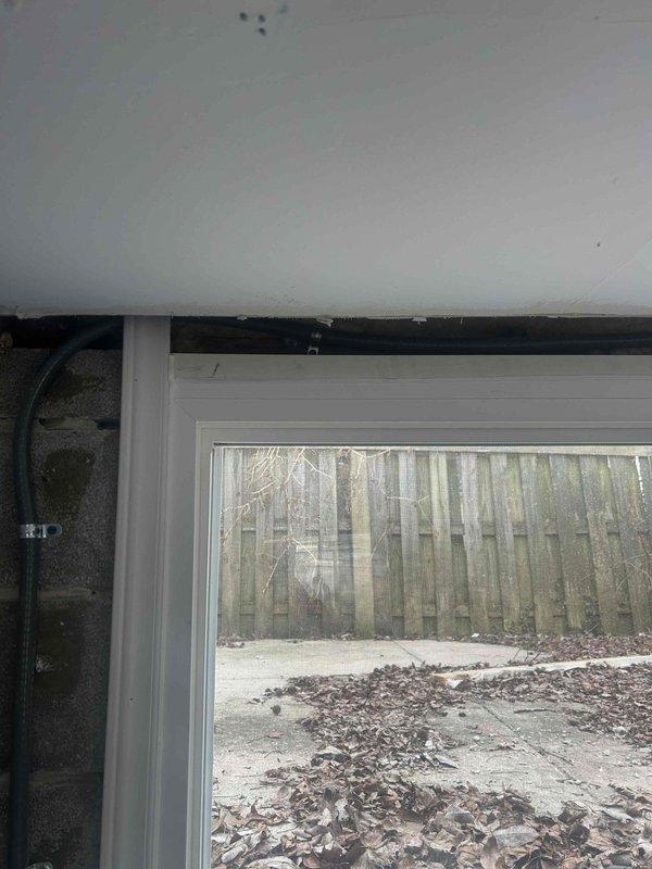 Successfully installed protective conduit strapping along the window frame to secure existing cable run. Verified installation integrity and proper cable protection at all attachment points. Key was returned to mailbox upon completion.