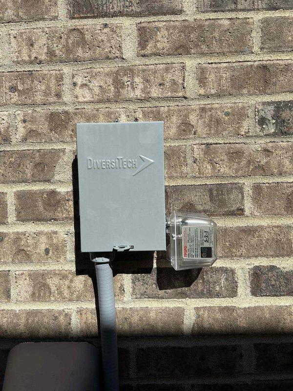 Performed routine Club Duo maintenance on HP/AH and AC/GF units located in attic and basement. Conducted electrical testing with clamp meter showing 41.68A reading and inspected the DiversiTech disconnect box mounted on exterior brick wall, confirming proper installation and functionality of all components.