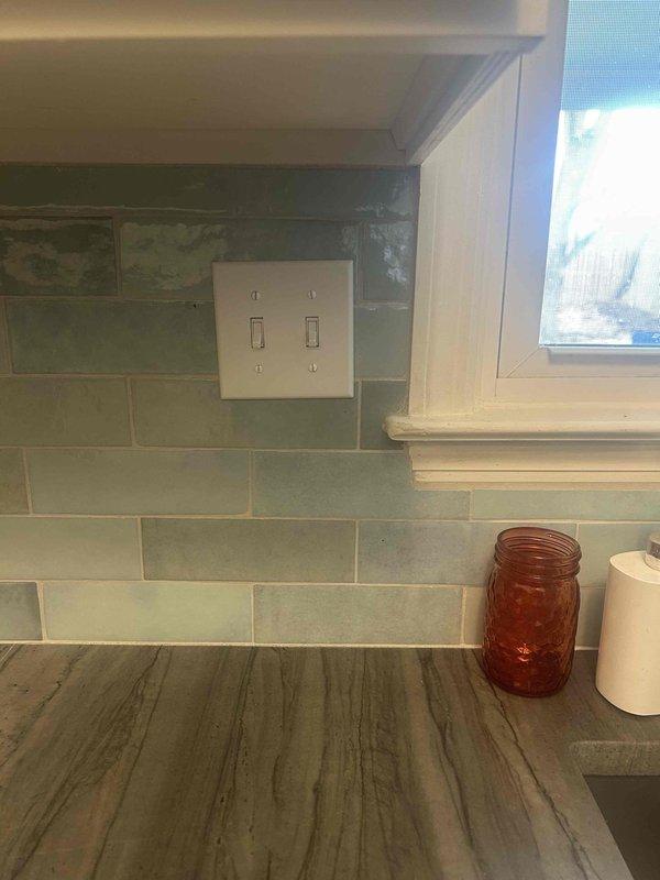 Diagnosed and repaired non-functioning kitchen outlet on tiled backsplash. Inspection revealed loose connection at receptacle terminal; removed outlet cover, tightened all terminal screws, and verified proper voltage. Tested outlet functionality with circuit tester confirming restoration of power to the previously non-working receptacle.