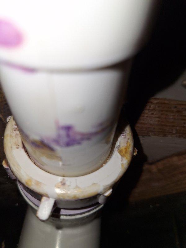 Identified water leakage from shower/tub drain penetration affecting basement area. Inspection revealed deteriorated seal around drain pipe with visible discoloration and residue buildup at the coupling. Resealed pipe penetration with appropriate plumbing sealant to prevent further water intrusion during bath usage, restoring proper functionality.