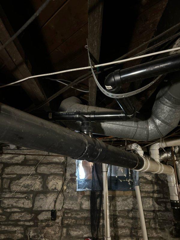 Identified water leakage from shower/tub drain penetration affecting basement area. Inspection revealed deteriorated seal around drain pipe with visible discoloration and residue buildup at the coupling. Resealed pipe penetration with appropriate plumbing sealant to prevent further water intrusion during bath usage, restoring proper functionality.