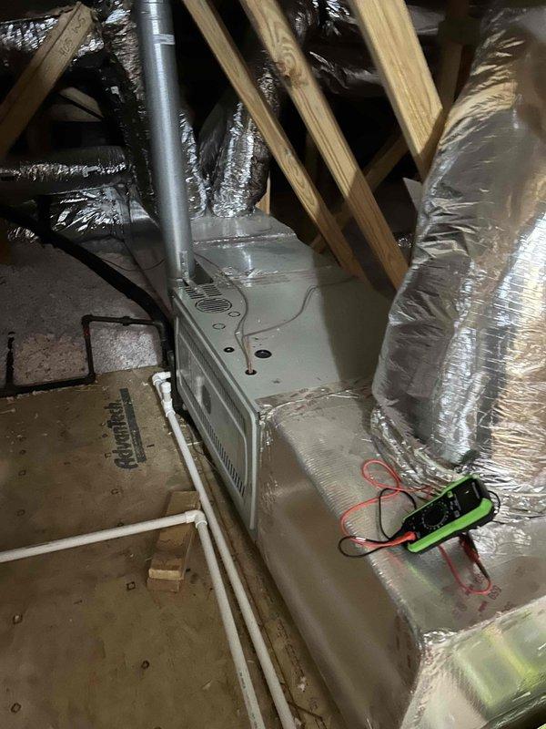 Responded to no-heat call for 45-year-old furnace system. Performed diagnostic testing in attic location using multimeter to identify system failure. Documented service with job number #28800315 for warranty purposes.