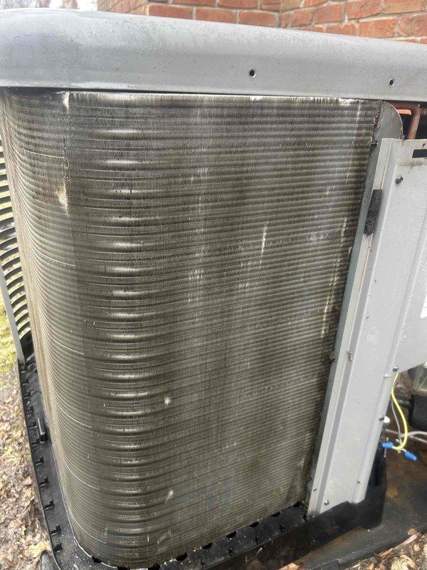 Performed routine maintenance on residential AC system with 16x25x1 filter located in garage. Inspected outdoor condenser unit, noting dust/debris accumulation on coil fins requiring cleaning. Conducted electrical diagnostic testing with Fluke 376 FC meter, confirming proper voltage at 245.7 VAC.
