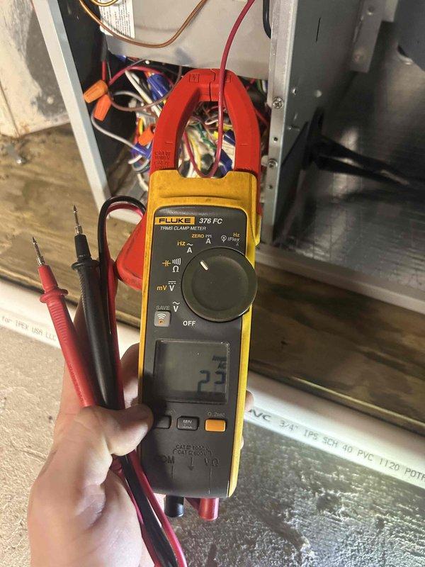 Performed Care Plan Tune Up on heat pump and air handler located in basement. Conducted electrical diagnostics using Fluke 376 FC clamp meter, recording readings of 18.9 and 2.3 on system components. Inspected circuit board, terminal connections, and verified proper operation of all electrical components.