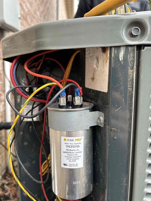 Completed replacement of capacitors on System 1-2 as documented with installation photos, showing proper wiring connections to the TITAN PRO TRCFD70S capacitor. Additionally, replaced UV bulbs in Systems 1-2 and 4, installed warranty-approved Lennox replacement heat kit for System 3, and replaced thermostat on System 5, resolving all identified issues across multiple HVAC systems.